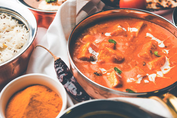 Indian Lunch / Dinner main course food in group includes Paneer Butter Masala, Dal Makhani, Palak Paneer, Roti, Rice etc, Selective focus