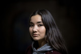 Portrait of young woman on a black background. Looking in the camera
