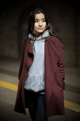 Photo of young woman in night subway. Looking to the side