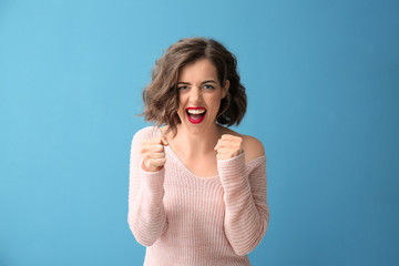 Portrait of beautiful emotional woman on color background