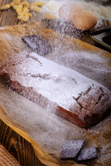 Fresh brownie from the oven on a wooden table
