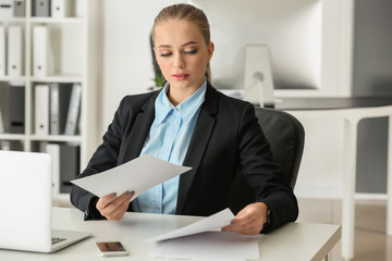 Beautiful female secretary working in office