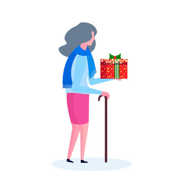 Senior woman with stick holding gift box