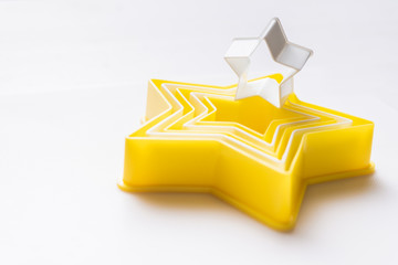 Cloase up star shaped pastry cutter on a white background