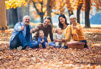 Multl generation family in autumn park having fun