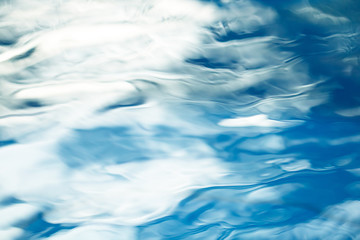 The smooth natural blue water background with bokeh  abstract on the sea or ocean,vintage and soft colored blur.