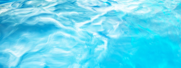 The smooth natural blue water background with bokeh  abstract on the sea or ocean,vintage and soft colored blur.