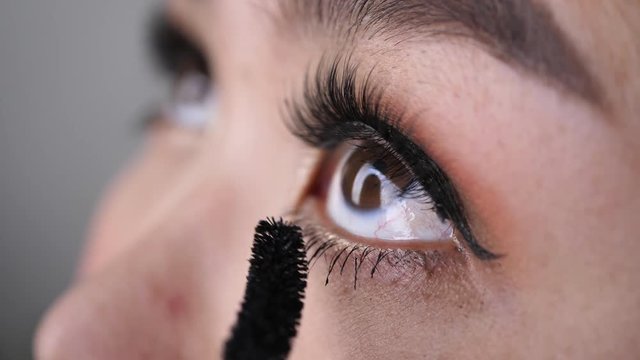 beautician using mascara brush makeup beauty eyelash