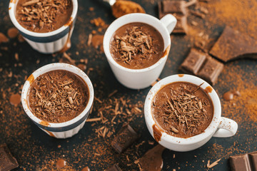 Tasty hot chocolate drink in small cups