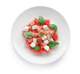 Plate with delicious watermelon salad on white background
