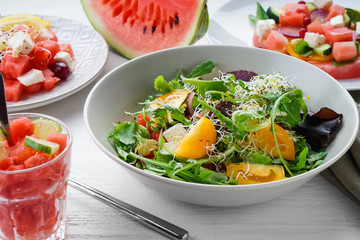 Plate with delicious watermelon salad on white table