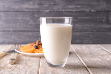 Glass of milk on wooden table