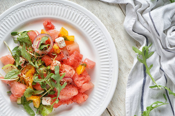 Delicious watermelon salad on plate, top view