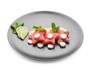 Plate with delicious sliced fruits and cheese on white background
