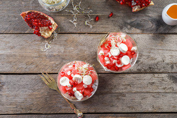 Glasses with delicious watermelon salad on wooden table, top view
