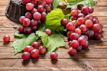 Ripe sweet grapes on wooden table