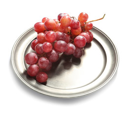Metal tray with red juicy grapes on white background