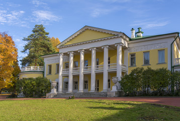 An old two-storey manor house with columns in autumn. Large clearing in front of the house. Gorky Leninskie, Lenin hills, Russia, the last location of Lenin.