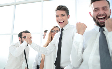 happy employees standing in spacious office