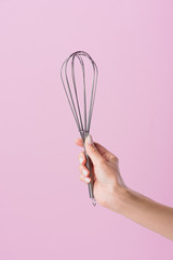 cropped shot of woman holding whisk isolated on pink