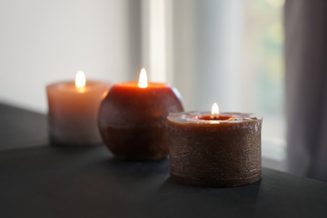 Fototapeta na wymiar Beautiful burning candles on dark table