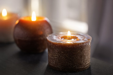 Beautiful burning candles on dark table