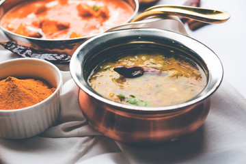 Dal Tadka Fry / Indian Lentil Curry served in a bowl with rice and roti, selective focus