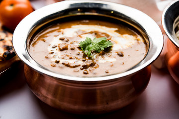 Dal makhani / makhni is a popular dish from India. Made with ingredients like whole black lentil, butter and cream. Served with Naan/roti and rice