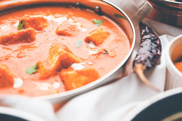Paneer Butter Masala or Cheese Cottage Curry in serving a bowl or pan, served with or without roti and rice