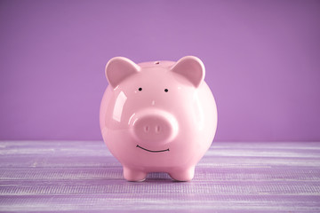 Cute piggy bank on table