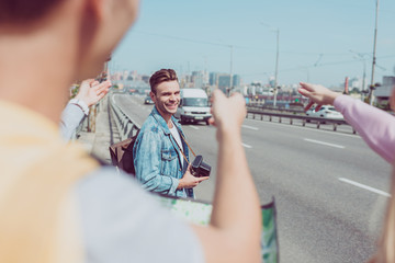 partial view of travelers looking for destination on map during trip in new city