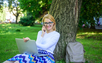 Woman with laptop in park order item on phone. Girl takes advantage of online shopping. Save your...