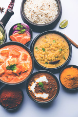 Indian Lunch / Dinner main course food in group includes Paneer Butter Masala, Dal Makhani, Palak Paneer, Roti, Rice etc, Selective focus
