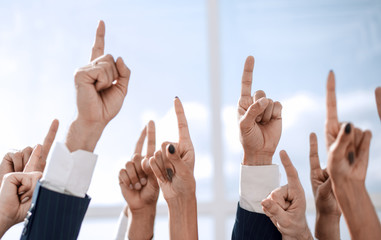 close up. business team pointing up to the copy space