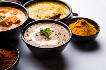 Dal makhani / makhni is a popular dish from India. Made with ingredients like whole black lentil, butter and cream. Served with Naan/roti and rice