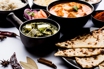 Indian Lunch / Dinner main course food in group includes Paneer Butter Masala, Dal Makhani, Palak Paneer, Roti, Rice etc, Selective focus