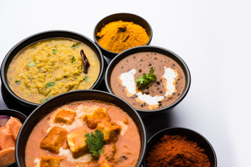 Indian Lunch / Dinner main course food in group includes Paneer Butter Masala, Dal Makhani, Palak Paneer, Roti, Rice etc, Selective focus