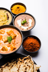 Indian Lunch / Dinner main course food in group includes Paneer Butter Masala, Dal Makhani, Palak Paneer, Roti, Rice etc, Selective focus