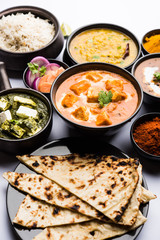 Indian Lunch / Dinner main course food in group includes Paneer Butter Masala, Dal Makhani, Palak Paneer, Roti, Rice etc, Selective focus