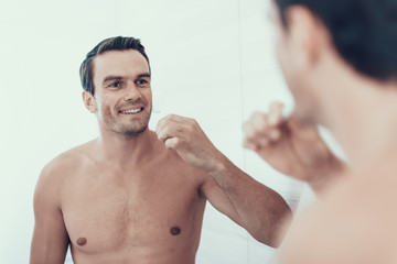 Mirror Reflection of Man Brush Teeth in Bathroom