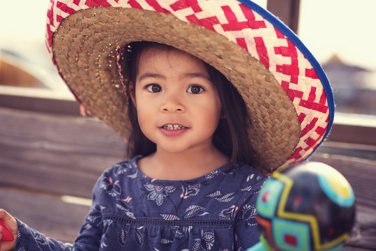 Young Girl Wearing A Sombrero