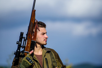 Hunting masculine hobby concept. Man brutal guy gamekeeper nature background. Regulation of...