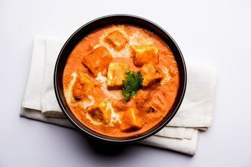 Paneer Butter Masala or Cheese Cottage Curry in serving a bowl or pan, served with or without roti...