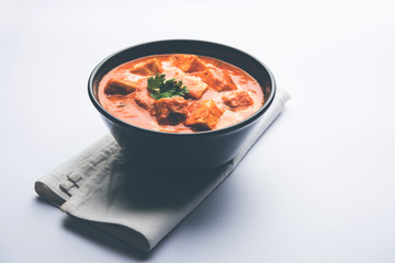 Paneer Butter Masala or Cheese Cottage Curry in serving a bowl or pan, served with or without roti and rice