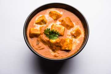 Paneer Butter Masala or Cheese Cottage Curry in serving a bowl or pan, served with or without roti and rice