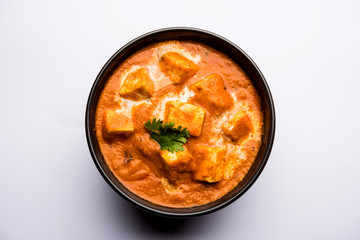 Paneer Butter Masala or Cheese Cottage Curry in serving a bowl or pan, served with or without roti and rice - obrazy, fototapety, plakaty