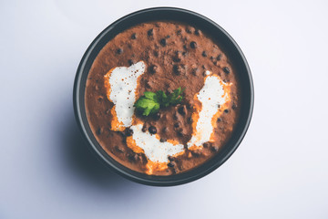 Dal makhani / makhni is a popular dish from India. Made with ingredients like whole black lentil, butter and cream. Served with Naan/roti and rice