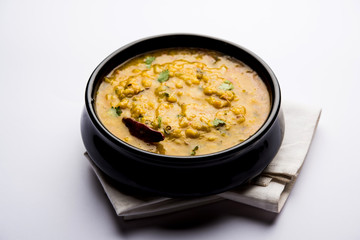 Dal Tadka Fry / Indian Lentil Curry served in a bowl with rice and roti, selective focus