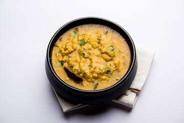 Dal Tadka Fry / Indian Lentil Curry served in a bowl with rice and roti, selective focus
