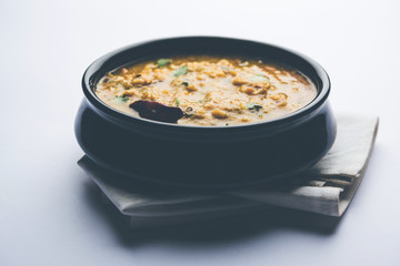 Dal Tadka Fry / Indian Lentil Curry served in a bowl with rice and roti, selective focus